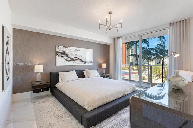 bedroom with a textured ceiling and an inviting chandelier