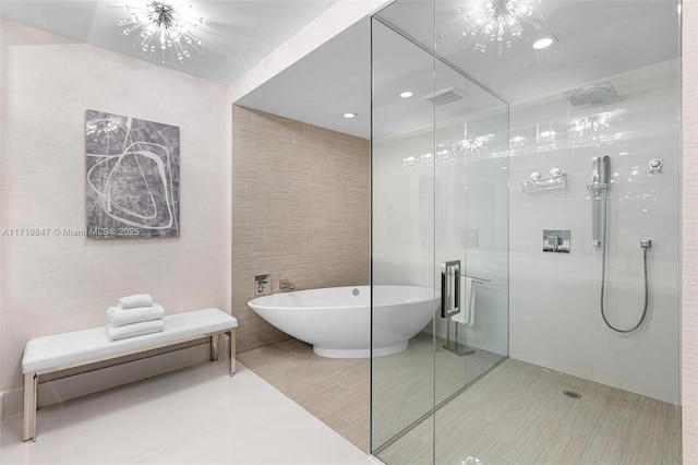 bathroom featuring separate shower and tub, tile patterned flooring, tile walls, and a notable chandelier