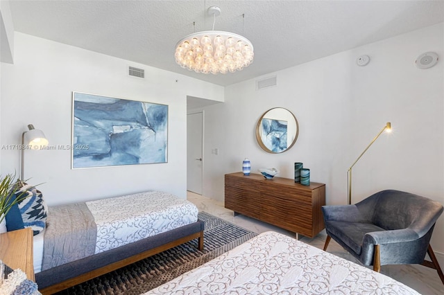 bedroom featuring a textured ceiling and an inviting chandelier