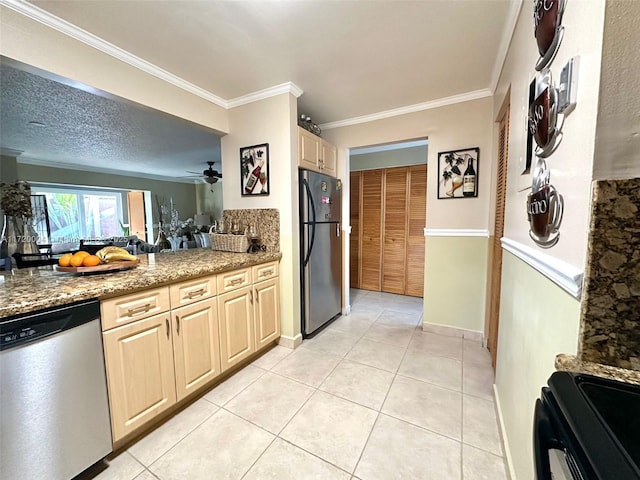 kitchen with ceiling fan, light tile patterned floors, stainless steel appliances, and ornamental molding