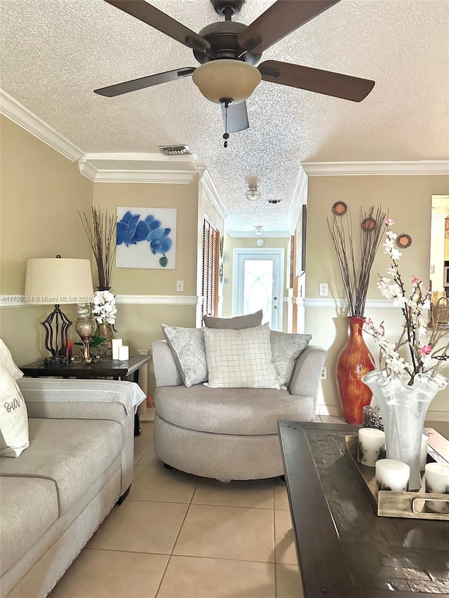 tiled living room featuring ceiling fan, crown molding, and a textured ceiling