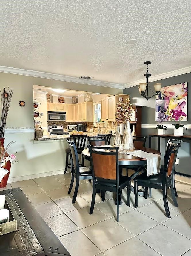 tiled dining room with a chandelier and crown molding