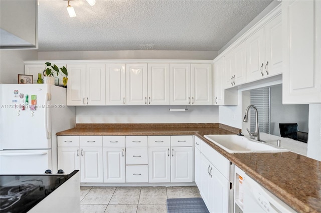 kitchen with a textured ceiling, sink, white cabinets, and white appliances