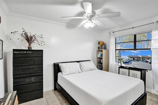 tiled bedroom featuring ceiling fan, ornamental molding, and a textured ceiling