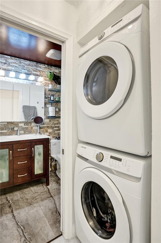 laundry room with stacked washer / dryer