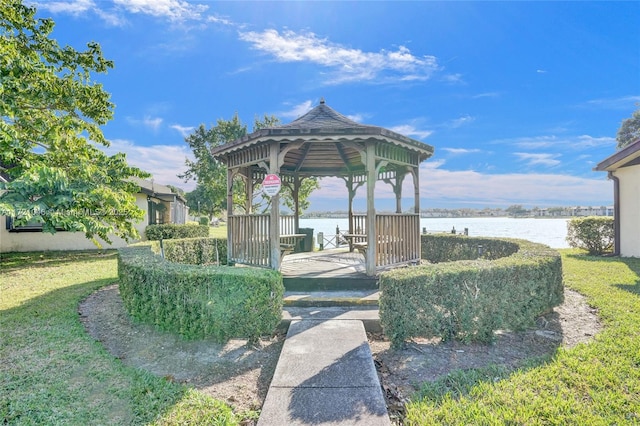 view of community featuring a gazebo, a water view, and a lawn