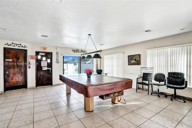 playroom with light tile patterned floors, a textured ceiling, and billiards