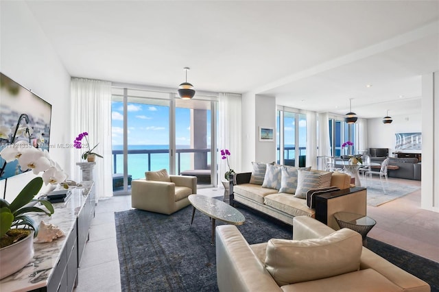 living room with floor to ceiling windows and a water view