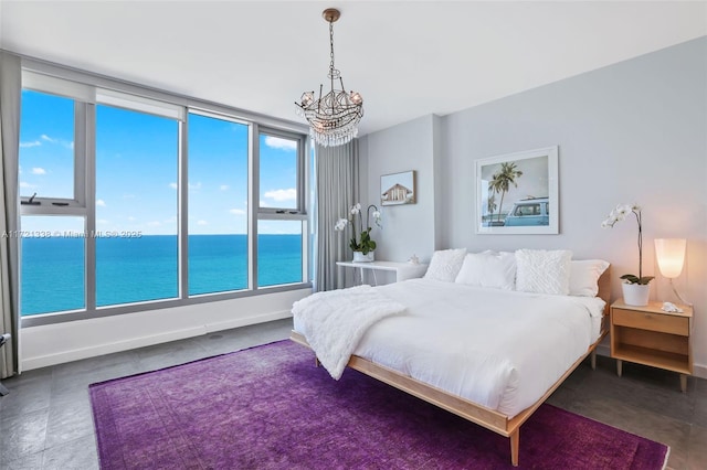 bedroom with a notable chandelier and a water view