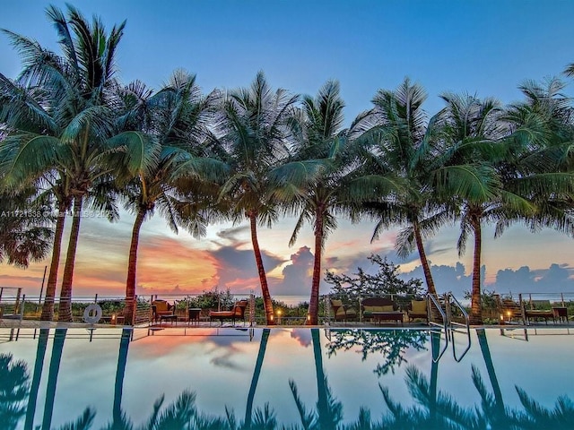 view of pool at dusk