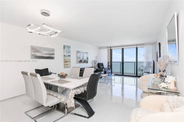 dining space featuring light tile patterned floors and expansive windows