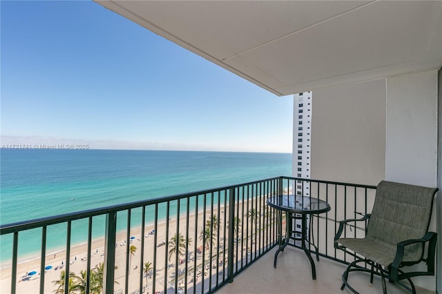 balcony featuring a water view and a beach view