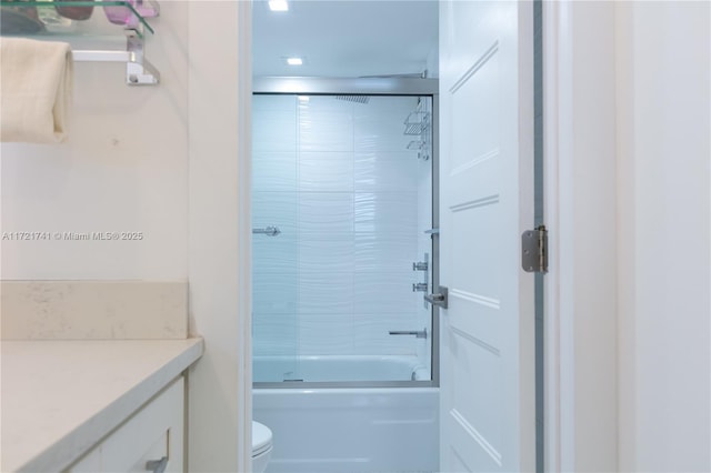 full bathroom with vanity, toilet, and enclosed tub / shower combo