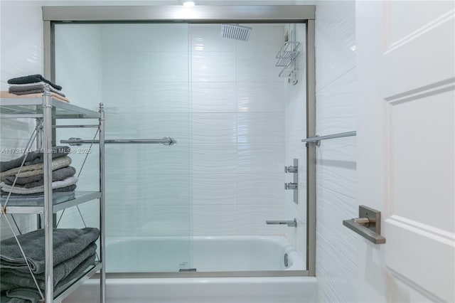 bathroom featuring bath / shower combo with glass door