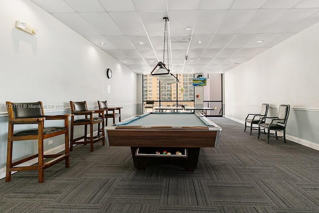 game room featuring a paneled ceiling, dark colored carpet, and pool table