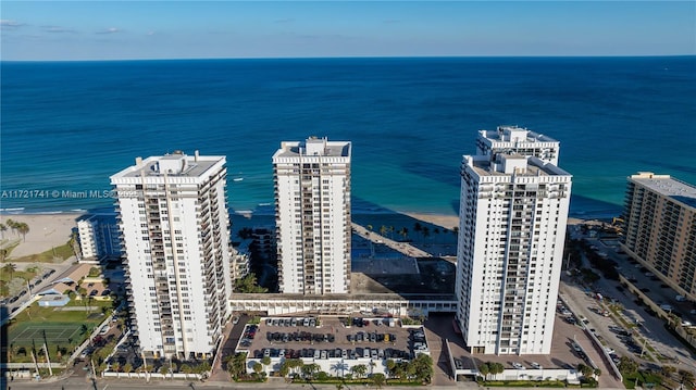 aerial view with a water view and a beach view