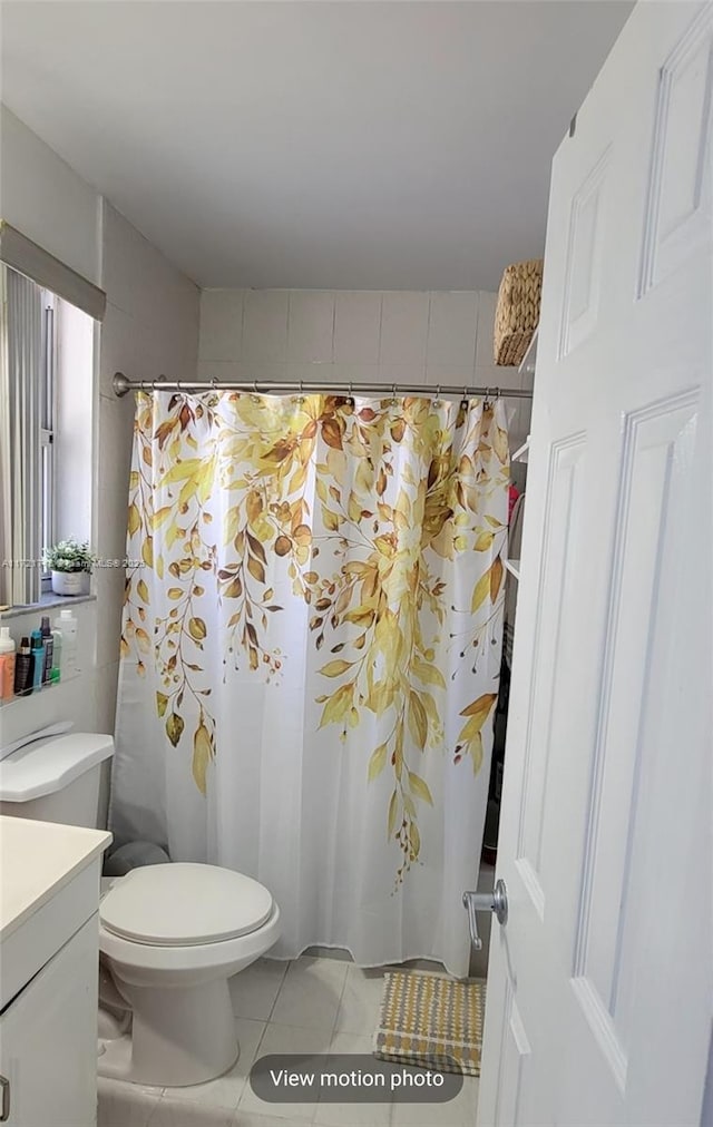 bathroom featuring tile patterned floors, vanity, a shower with shower curtain, and toilet