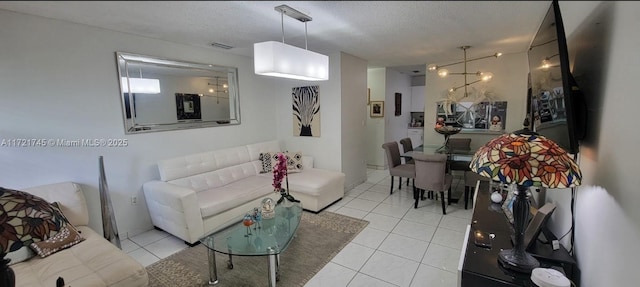 living room with light tile patterned flooring and a textured ceiling