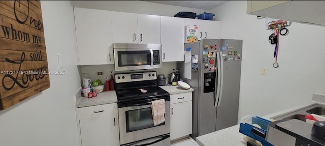 kitchen with white cabinetry and stainless steel appliances