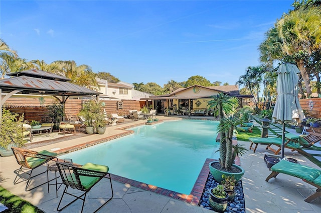 view of swimming pool featuring a gazebo and a patio