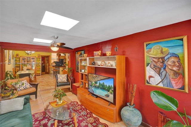 tiled living room featuring a skylight and ceiling fan