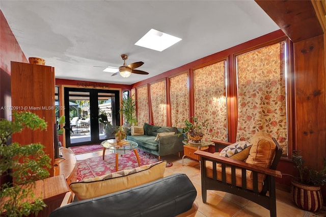 interior space featuring ceiling fan, french doors, and a skylight