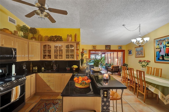 kitchen with stainless steel appliances, sink, light brown cabinets, a breakfast bar area, and light tile patterned flooring