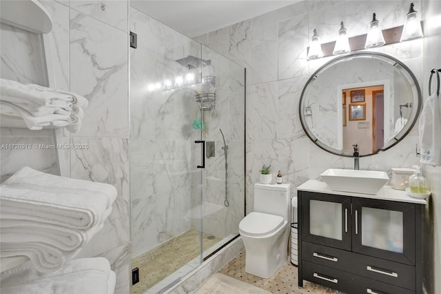 bathroom featuring vanity, an enclosed shower, tile walls, and toilet