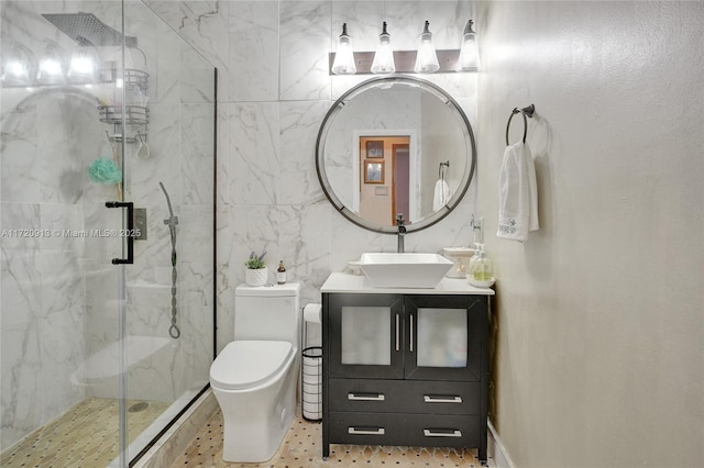 bathroom with tile patterned floors, vanity, a shower with shower door, and toilet