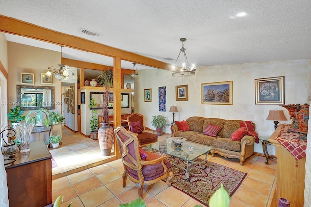 living room featuring a notable chandelier, beam ceiling, light tile patterned floors, and a textured ceiling