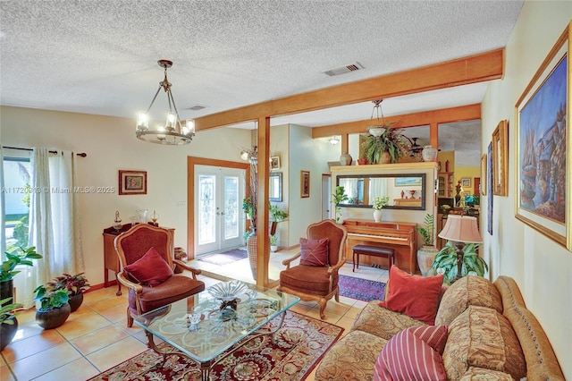 tiled living room featuring beamed ceiling, french doors, an inviting chandelier, and plenty of natural light