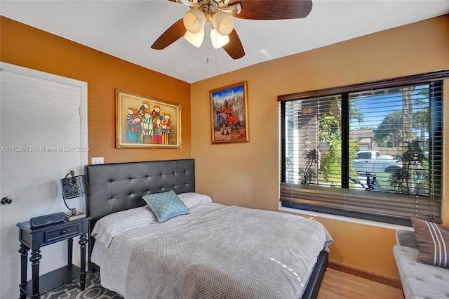 bedroom with ceiling fan and light hardwood / wood-style flooring