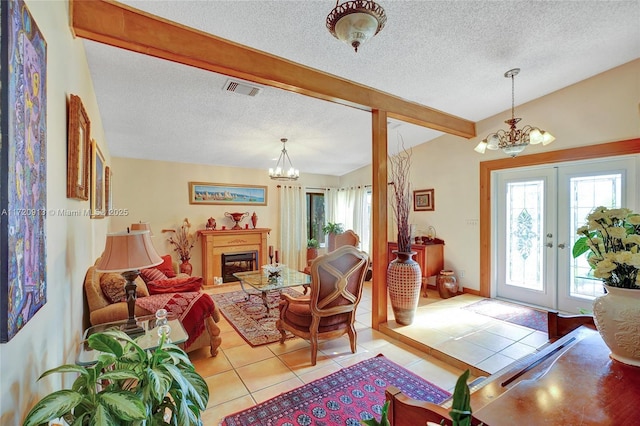 tiled living room with french doors, lofted ceiling with beams, a textured ceiling, and an inviting chandelier