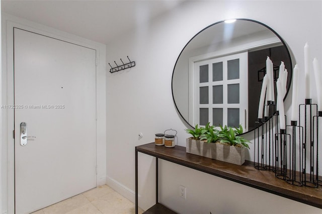 doorway to outside featuring light tile patterned floors