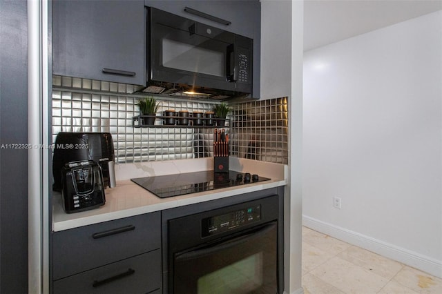 kitchen featuring black appliances, light tile patterned floors, and backsplash