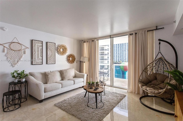 tiled living room featuring floor to ceiling windows