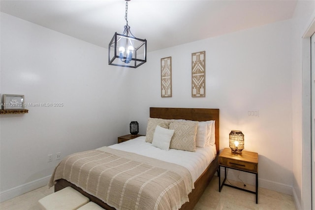 bedroom featuring an inviting chandelier