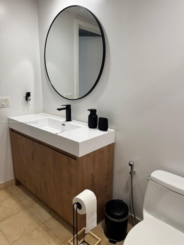 bathroom with tile patterned floors, vanity, and toilet