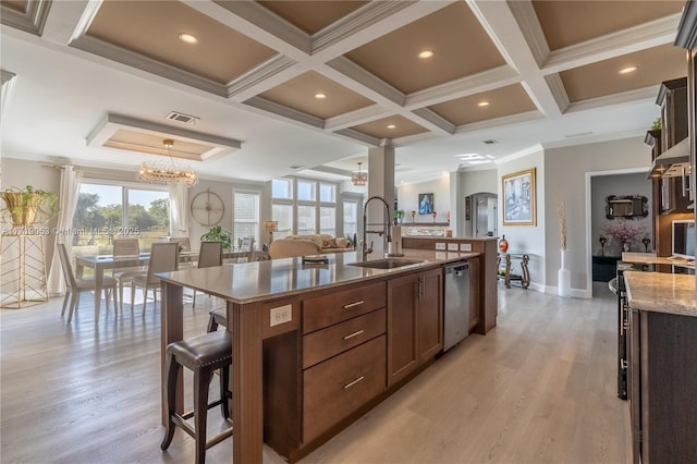 kitchen with a large island, sink, dishwasher, light hardwood / wood-style flooring, and ornamental molding