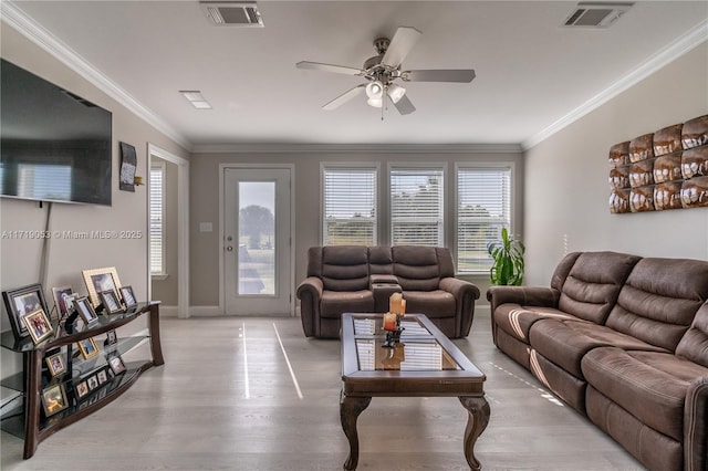 living room featuring light wood-type flooring, ceiling fan, and crown molding