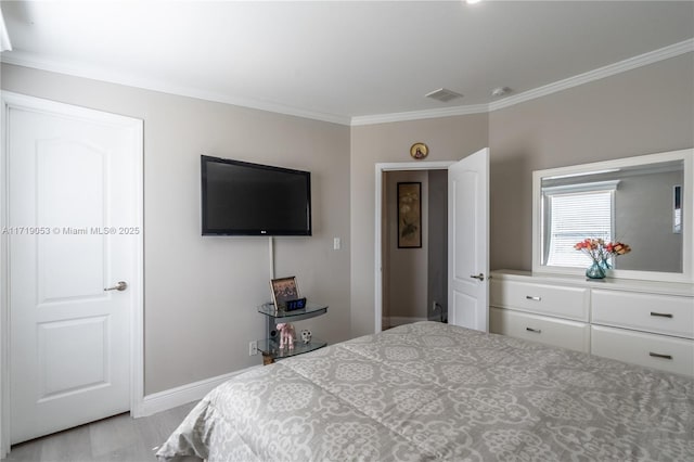 bedroom with light hardwood / wood-style flooring and crown molding