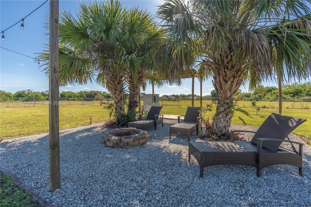 view of yard with a patio, a rural view, and a fire pit