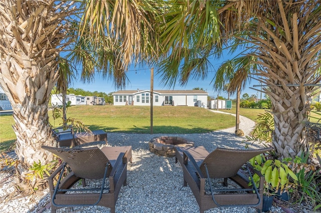 view of yard featuring a patio and an outdoor fire pit