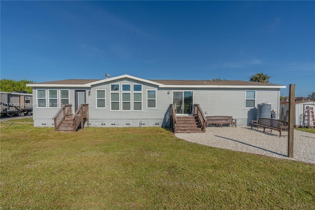 rear view of property with a yard