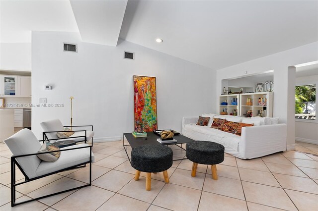 tiled living room with lofted ceiling