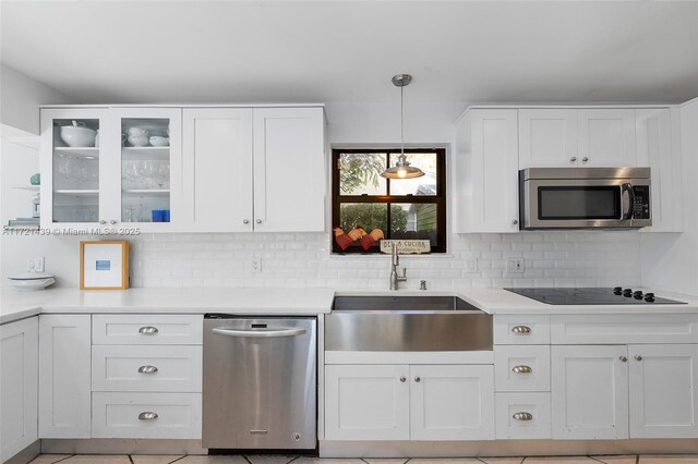 kitchen with white cabinetry, appliances with stainless steel finishes, sink, and pendant lighting