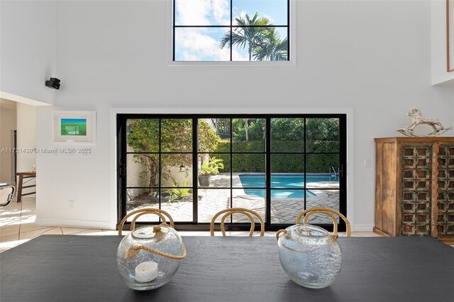 tiled dining room with a high ceiling