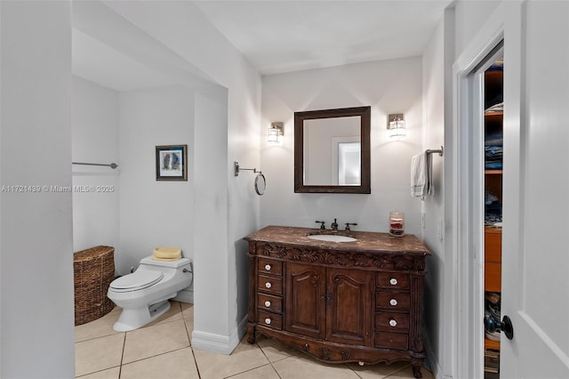 bathroom featuring tile patterned flooring, vanity, and toilet