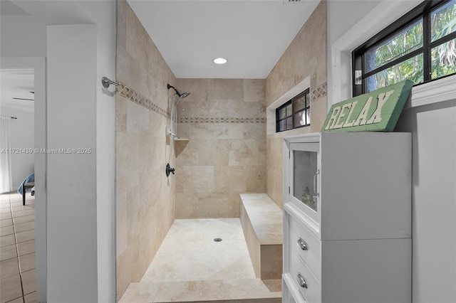 bathroom with plenty of natural light, a tile shower, and tile patterned floors