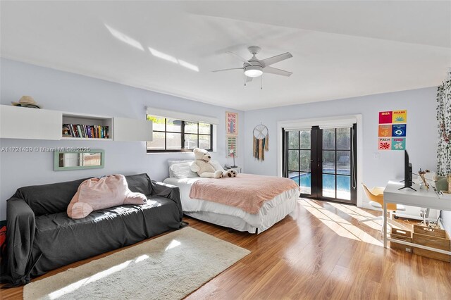 bedroom featuring french doors, ceiling fan, light hardwood / wood-style flooring, and access to outside